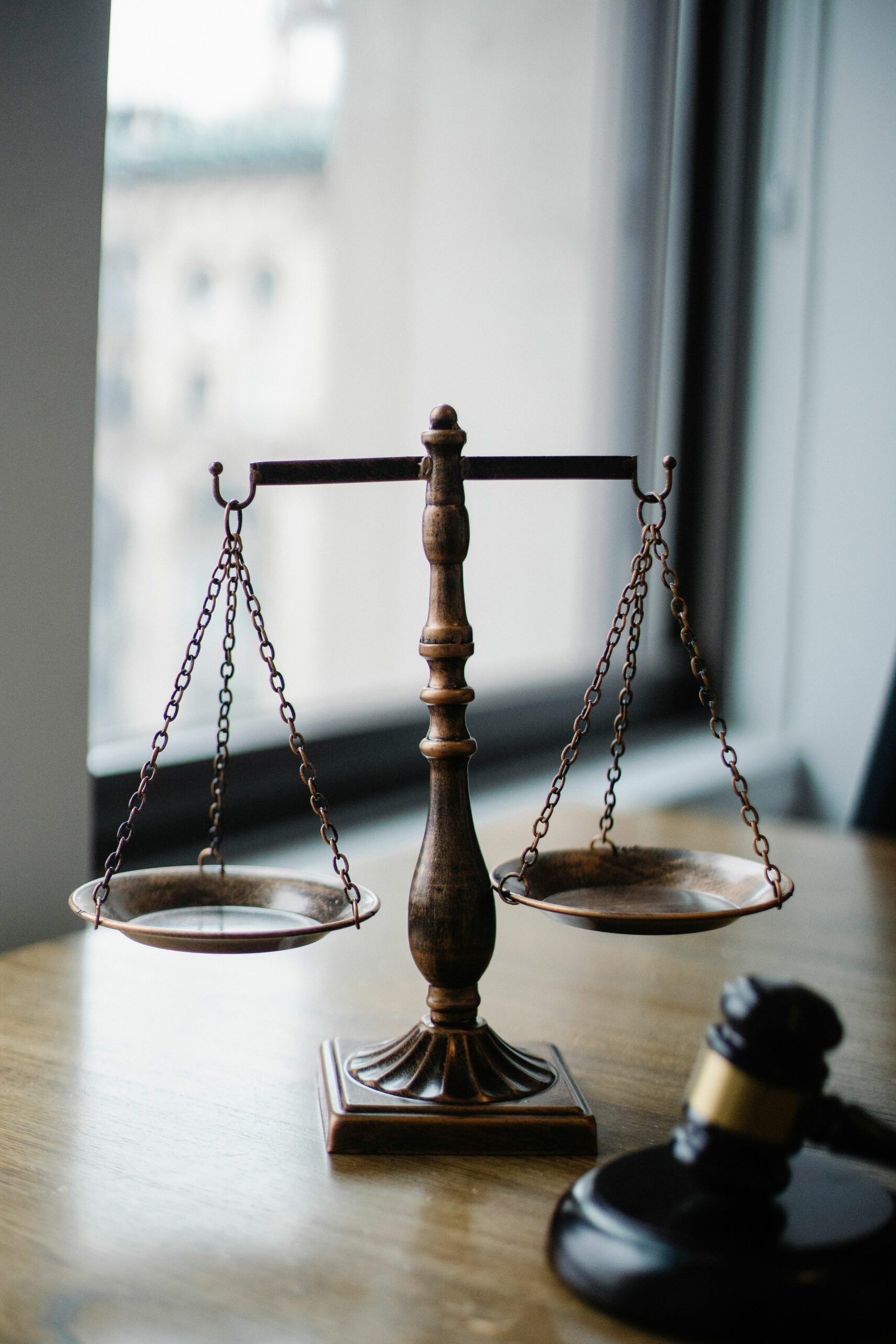 pexels photo 5669602 5669602 Decorative judgement scale and gavel placed on desk in light lawyer office against window